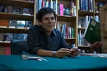 Aitken signing copies of his book Eighth Habitation at Gleebooks, 2009