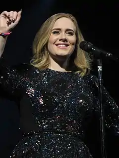 A photograph of Adele performing live.