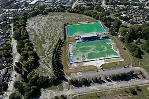 Aerial view of Porritt Park after the February 2011 Christchurch earthquake, showing extensive soil liquefaction