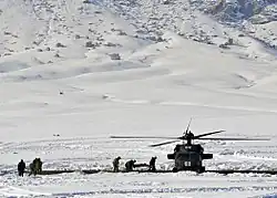 Afghan Local Police and coalition special operations forces load a police member needing medical care onto an MH-60 Black Hawk helicopter during a medical evacuation in January 2012