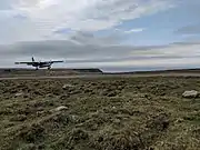 Photograph of an aircraft landing at Foula Airfield