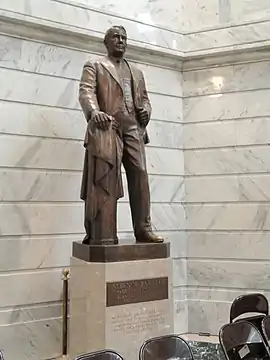 A bronze sculpture of Vice President Alben W. Barkley standing atop a marble base, as seen inside the rotunda of the Kentucky State Capitol