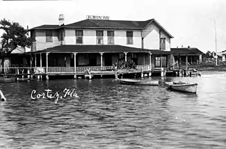 hotel on waterfront with fishing boats tied up in the water