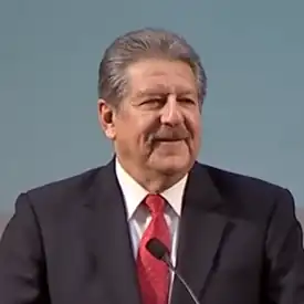 Alexander Gonzalez standing at a lectern as he delivers the 2014 Spring Address to students and faculty at Sacramento State