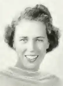 A smiling young white woman with short curly hair, from a 1939 yearbook