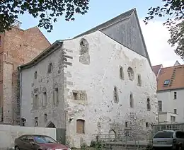 An old stone building with a wooden roof