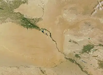 A topographic map showing the Amu Darya river and Bukhara Oasis map. Amu Darya flows from the top left corner to the bottom centre. In the bottom left corner of the map  lies the Bukhara Oasis.