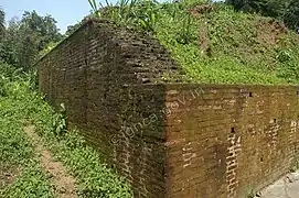 Section of the fortified brick wall leading to the western gateway.