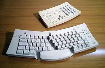 The Apple Adjustable Keyboard (1992) splits the alphanumeric keys into two halves with an adjustable opening angle