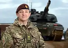 A British soldier in front of a tank