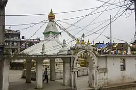 Gate to the Northern Ashok Stupa in Patan, with a built-in jahru on the right of the arch