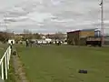 Cricket pitch end and cricket pavilion with changing rooms underneath.