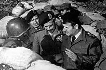 Uniformed men in a foxhole