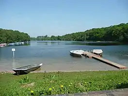 Biats and a Jetty on a lake surrounded by trees