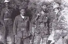 Four men in a mountain landscape