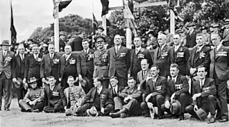 a group black and white photograph of males wearing suits and medals