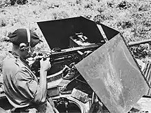 Black and white photo of a soldier with a machine gun