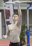 Clearly visible serratus anterior muscle of the artistic gymnast Calvin Currie during preparation of the parallel bars at the Austrian Future Cup in Linz.