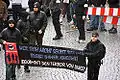 Autonome Nationalisten/Autonomous Nationalists at a 2006 protest. The black and red flags on the banner are of the Antifaschistische Aktion's logo