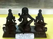 Ayynar with his consorts Poorna and Pushkala, 7th century.