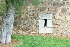 Spillway or sewer at the bottom of a curtain wall