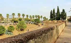 Western curtain wall with embrasures defending the moat and east descent