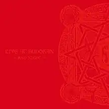 A red album cover, with the words "LIVE AT BUDOKAN" and "~RED NIGHT~" on the left side and one half of a circular design on the right side, both in a lighter red color.