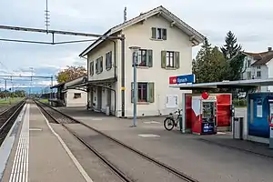 Three-story building beside two railway tracks