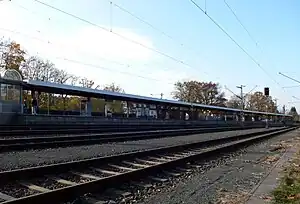 Looking across three railroad tracks at island platform