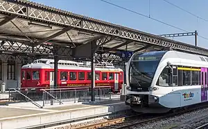 White train stopped at side platform