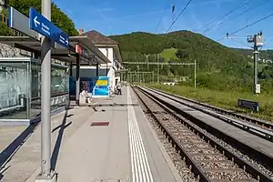 Two-story building with hip roof on platform with double track