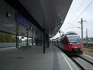 Red train at covered platform