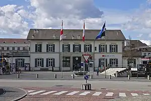 Wide three-story building with gabled roof