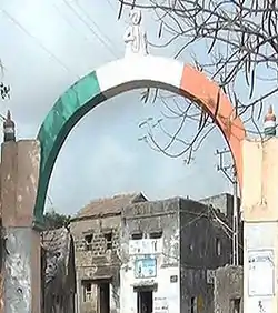 Bakharla Monument: an Indian tricolour painted  arch at an entrance to the gham