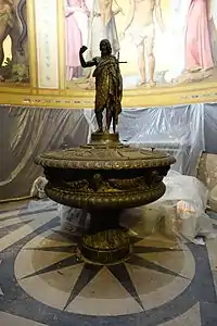 The baptismal font, with figure  of John the Baptist