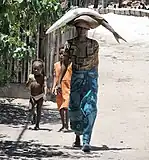 Woman carrying a barracuda in Madagascar