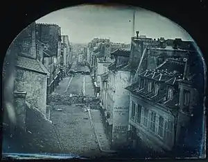 Image 4Barricades on rue Saint-Maur (1848), the first photo used to illustrate a newspaper story (from Photojournalism)