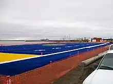 The blue and yellow field of northern Alaska's Barrow High School is also the northernmost American football field in the world.