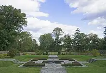 A terraced garden to the east of the house, which has a square fountain in the center