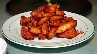 Sweet potato with caramelised sugar (拔丝地瓜; 拔絲地瓜; básī dìguā; 'pull-out silk sweet potato')