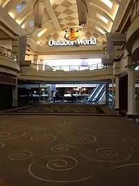 A concourse of Forest Fair Village shopping mall, showing the entrance to Bass Pro Shops.