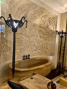 Bath of Jeanne Lanvin, of Sienna marble, with decoration of carved stucco and bronze (1922–1925)