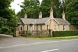 Single storey building surrounded by high fence.