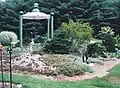 A perennial bed on ledge with sculptures