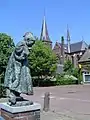 Beers, church and statue of child dressed up as elderly woman