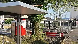 Canopy-covered waiting area and bicycle racks