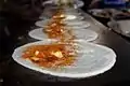 A view of making benne dosa at a restaurant