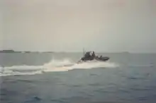 A motorboat of the Bermuda Regiment Boat Troop moves out of the Great Sound, past the HMD, Bermuda, on Ireland Island.