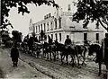 Artillery hauling through the damaged streets of the village during WWI (1915)