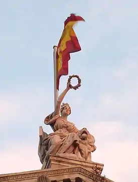 Finial figure of Spain with circular garland, atop the Biblioteca Nacional de España, Madrid, 1892-1903